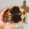 The Brookie Cookie - hand holding cookie split open showing fudgy brownie center